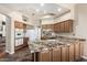 Bright kitchen with granite countertops, wood cabinets, and modern appliances at 7955 E Chaparral Rd # 17, Scottsdale, AZ 85250