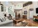 Open-concept living room with fireplace, high ceilings, and a staircase at 7955 E Chaparral Rd # 17, Scottsdale, AZ 85250