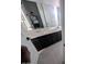 Bathroom featuring a vanity with countertop, dark cabinets and a mirror at 9548 E Rainbow Ave, Mesa, AZ 85212