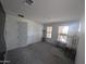 A tidy bedroom with neutral walls, carpet flooring, ample natural light, and a wardrobe and desk at 9548 E Rainbow Ave, Mesa, AZ 85212