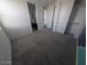 Cozy bedroom with neutral carpet and a glimpse into the adjacent bathroom at 9548 E Rainbow Ave, Mesa, AZ 85212