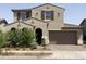 Charming two-story home with a well-maintained yard and a paved driveway leading to a two-car garage at 9548 E Rainbow Ave, Mesa, AZ 85212