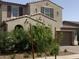 Inviting two-story home with lush landscaping and a paved driveway leading to a two-car garage at 9548 E Rainbow Ave, Mesa, AZ 85212