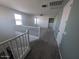 Hallway upstairs featuring carpet flooring, white trim, and doorways leading to bedrooms and baths at 9548 E Rainbow Ave, Mesa, AZ 85212