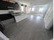 Modern kitchen with dark cabinets, gray tile flooring, a center island, and stainless steel appliances at 9548 E Rainbow Ave, Mesa, AZ 85212