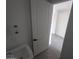 A clean laundry room with a white utility sink and tiled floors at 9548 E Rainbow Ave, Mesa, AZ 85212