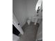 A compact powder room features a pedestal sink and toilet, maximizing space at 9548 E Rainbow Ave, Mesa, AZ 85212