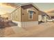 Well-maintained home exterior featuring neutral siding, a covered carport, and tidy landscaping at 320 E Mckellips Rd # 195, Mesa, AZ 85201