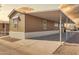 Charming home exterior with a covered carport and well-maintained landscaping at 320 E Mckellips Rd # 195, Mesa, AZ 85201
