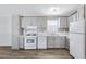 A well-lit kitchen with grey cabinets, marble countertops, and modern appliances at 320 E Mckellips Rd # 195, Mesa, AZ 85201