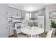Charming kitchen featuring grey cabinets, marble countertops, and a cozy dining area at 320 E Mckellips Rd # 195, Mesa, AZ 85201