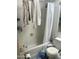 Full bathroom with white tile, standard tub/shower combination, and updated toilet, functional and ready for renovation at 3324 W Mcrae Way # 2, Phoenix, AZ 85027