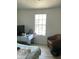 Bright bedroom with a window and natural light, furnished with a chair, bed and desk at 3324 W Mcrae Way # 2, Phoenix, AZ 85027