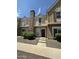 Townhouse style home with a brick chimney, landscaping and a gravel yard on a sunny day at 3324 W Mcrae Way # 2, Phoenix, AZ 85027