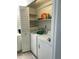 Laundry room features a white washer and dryer, storage shelves, and a cabinet, offering efficient laundry solutions at 3324 W Mcrae Way # 2, Phoenix, AZ 85027