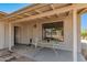 Covered back porch with seating area and views of the backyard at 44446 N 14Th St, New River, AZ 85087