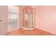 Bathroom featuring a corner shower, pink walls and wood flooring at 44446 N 14Th St, New River, AZ 85087