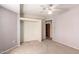 Bedroom featuring neutral walls, carpet, and an open doorway with built-in shelving at 44446 N 14Th St, New River, AZ 85087