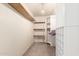 Walk-in closet with built-in wood and wire shelves at 44446 N 14Th St, New River, AZ 85087