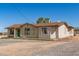 A cozy one-story home with a brown roof, a green door, and desert landscape in the background at 44446 N 14Th St, New River, AZ 85087