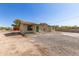 A cozy home surrounded by desert plants and a clear blue sky with a gravel front yard at 44446 N 14Th St, New River, AZ 85087