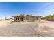 A cozy home with a green door, brown roof, desert plants, and a spacious gravel front yard at 44446 N 14Th St, New River, AZ 85087