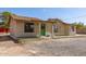A quaint house with a brown roof and a green door, surrounded by a gravel yard at 44446 N 14Th St, New River, AZ 85087