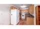 Kitchen featuring wooden cabinetry, white refrigerator and range at 44446 N 14Th St, New River, AZ 85087