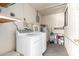 Laundry room with washer, dryer, water heater, and shelving at 44446 N 14Th St, New River, AZ 85087