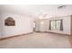 Bright living room with carpet flooring, ceiling fan, and a view to other rooms at 44446 N 14Th St, New River, AZ 85087