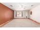 Cozy living room with carpet flooring, ceiling fan, natural light, and adjacent open-plan space at 44446 N 14Th St, New River, AZ 85087