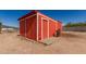 Bright red outbuilding with a matching door, providing ample storage space for outdoor equipment and tools at 44446 N 14Th St, New River, AZ 85087