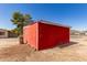 Sturdy red outbuilding with a metal roof, perfect for storage or a workshop, set in a rural landscape at 44446 N 14Th St, New River, AZ 85087