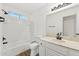 Bright bathroom featuring a shower-tub combo with white tiling, modern fixtures, and wood-look flooring at 4829 E Apache Cir, Phoenix, AZ 85044