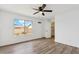 Inviting bedroom with a spacious closet, wood-look floors, and a large bright window at 4829 E Apache Cir, Phoenix, AZ 85044