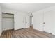Spacious bedroom featuring wood-look floors, closet with sliding doors, and neutral walls at 4829 E Apache Cir, Phoenix, AZ 85044
