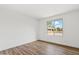 Cozy bedroom featuring wood-look floors and a bright window with a pleasant view at 4829 E Apache Cir, Phoenix, AZ 85044