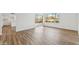 Bright living room featuring wood-look floors, a sliding glass door, and a large window with backyard views at 4829 E Apache Cir, Phoenix, AZ 85044