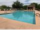 Community swimming pool with lounge chairs and shade structures at 5345 W Marcus Dr, Phoenix, AZ 85083