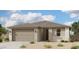 Inviting single-story home featuring a two-car garage, neutral stucco, and a well-maintained desert landscape at 5528 W Piedmont Rd, Laveen, AZ 85339