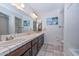 Bright bathroom with double vanity, tile counters and floors at 7645 W Bluefield Ave, Glendale, AZ 85308