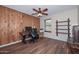 Bedroom with wood look floors and desk at 7645 W Bluefield Ave, Glendale, AZ 85308
