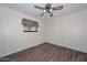 Bedroom featuring wood-look floors, ceiling fan and window with blinds at 7645 W Bluefield Ave, Glendale, AZ 85308