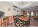 Inviting dining area with wood paneling and views of the bar, perfect for entertaining friends and Gathering at 7645 W Bluefield Ave, Glendale, AZ 85308
