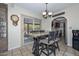 Open dining area featuring a modern light fixture, a sliding glass door, and a view into the kitchen at 7645 W Bluefield Ave, Glendale, AZ 85308