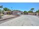 Wide driveway leading to a property with desert landscaping and a gated entrance at 7645 W Bluefield Ave, Glendale, AZ 85308