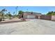 Property featuring a large garage, long driveway, desert landscaping, and a gated entrance at 7645 W Bluefield Ave, Glendale, AZ 85308