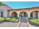 Charming arched entryway with desert landscaping and a unique brick facade at 7645 W Bluefield Ave, Glendale, AZ 85308