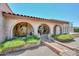 Beautiful arched entryway with brick accents and desert landscaping at 7645 W Bluefield Ave, Glendale, AZ 85308