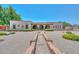 Expansive desert-landscaped front yard with a quaint walkway leading to the home's arched entryway at 7645 W Bluefield Ave, Glendale, AZ 85308